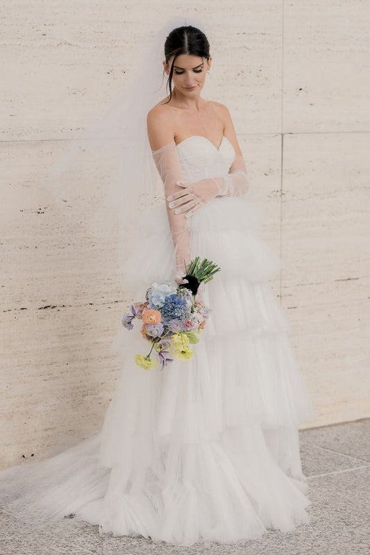 Custom tiered-skirt wedding gown with pleating and a natural train, designed from scratch for a slender bride by Angela Kim Couture