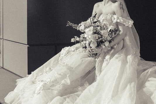Custom couture wedding gown designed from a single inspiration photograph, showing layered lace across the bodice and skirt
