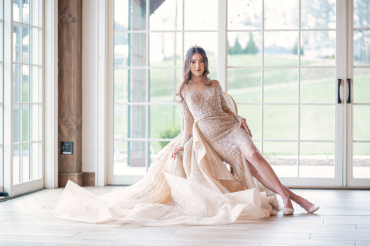 Custom nude-beige illusion-tulle wedding gown with metallic-accent beading and a detachable cascade overskirt by Angela Kim Couture