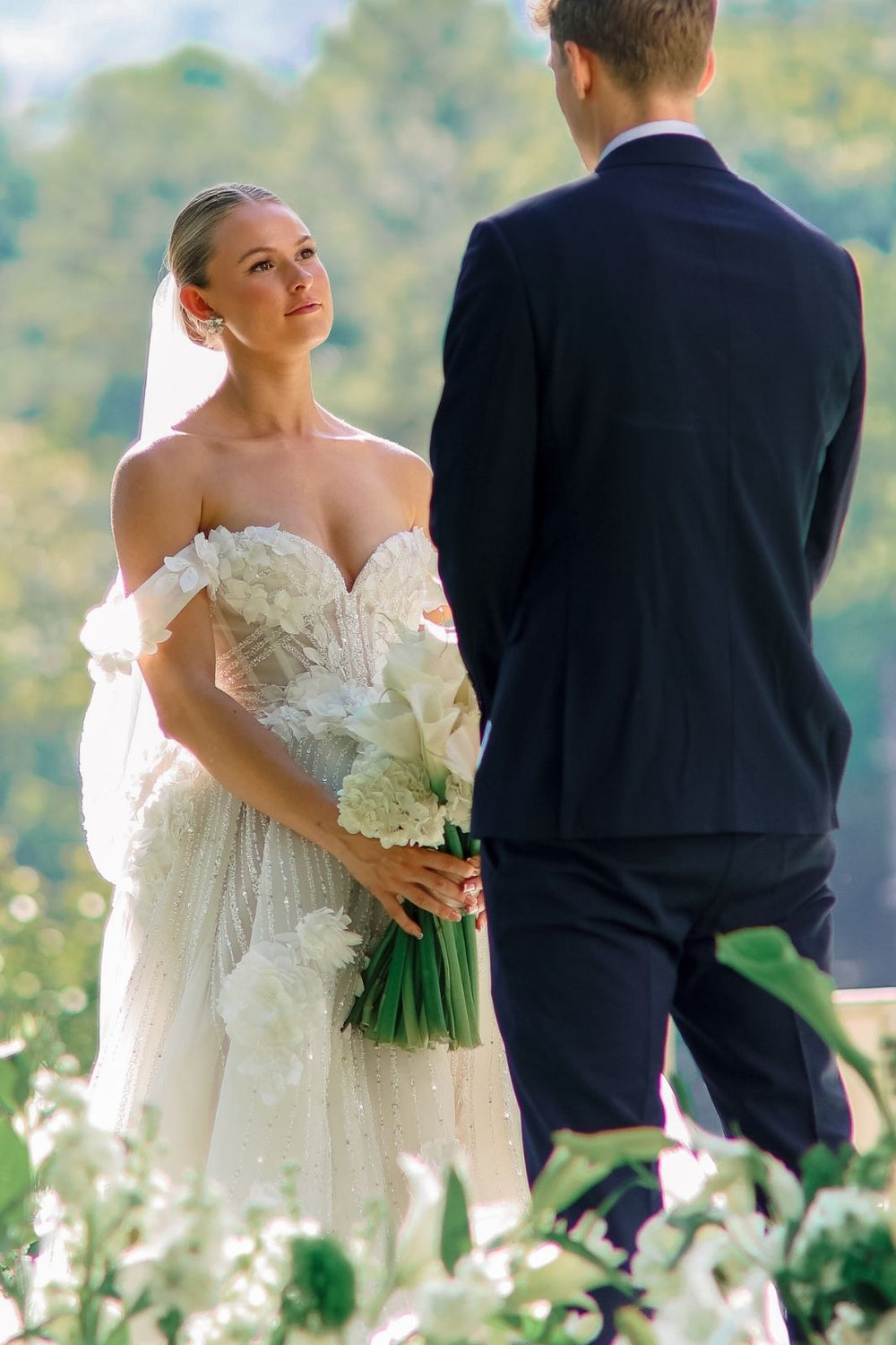 Bride wearing the ethereal Allure couture wedding gown at a spring wedding ceremony