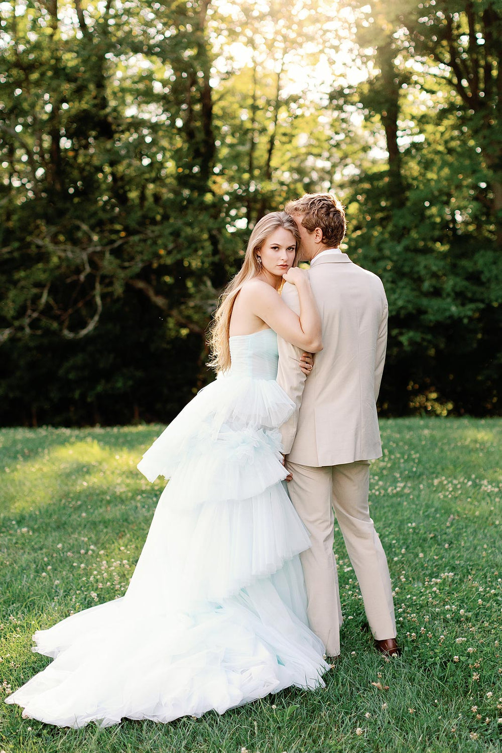 Side profile of the Belle sky-blue tiered tulle A-line wedding dress highlighting the full skirt volume