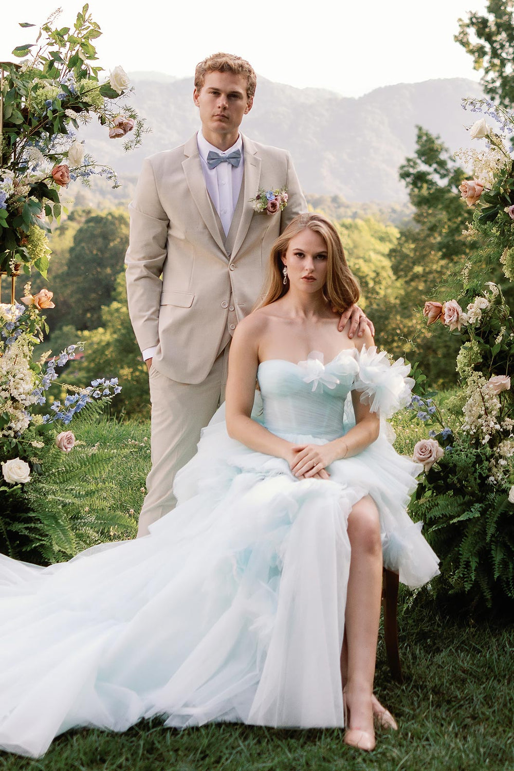 Romantic bridal portrait of bride wearing the Belle dreamy sky-blue tulle wedding dress with oversized flower detail