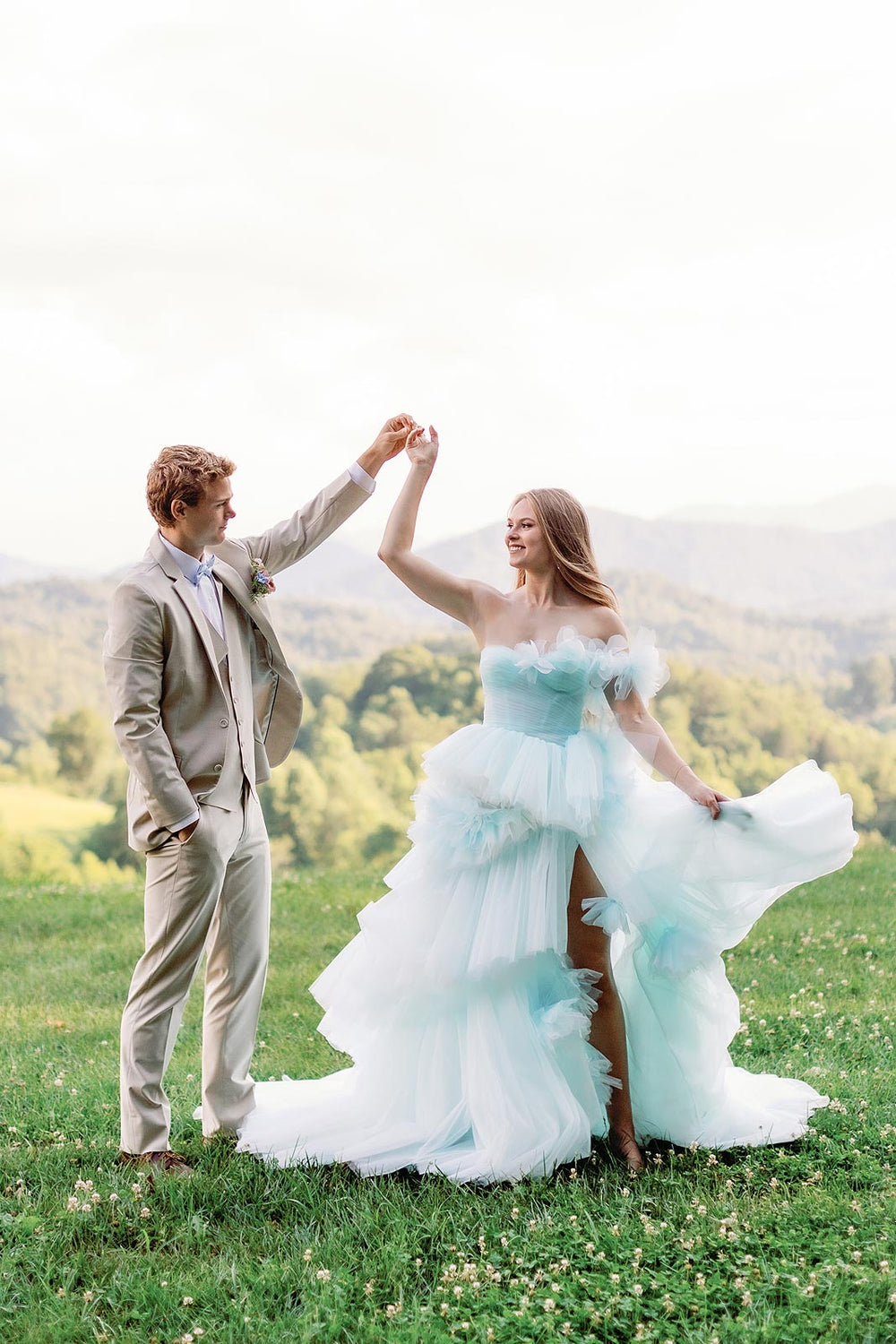 Outdoor bridal portrait in the Belle enchanted sky-blue tulle wedding gown with tiered skirt and floral embellishment