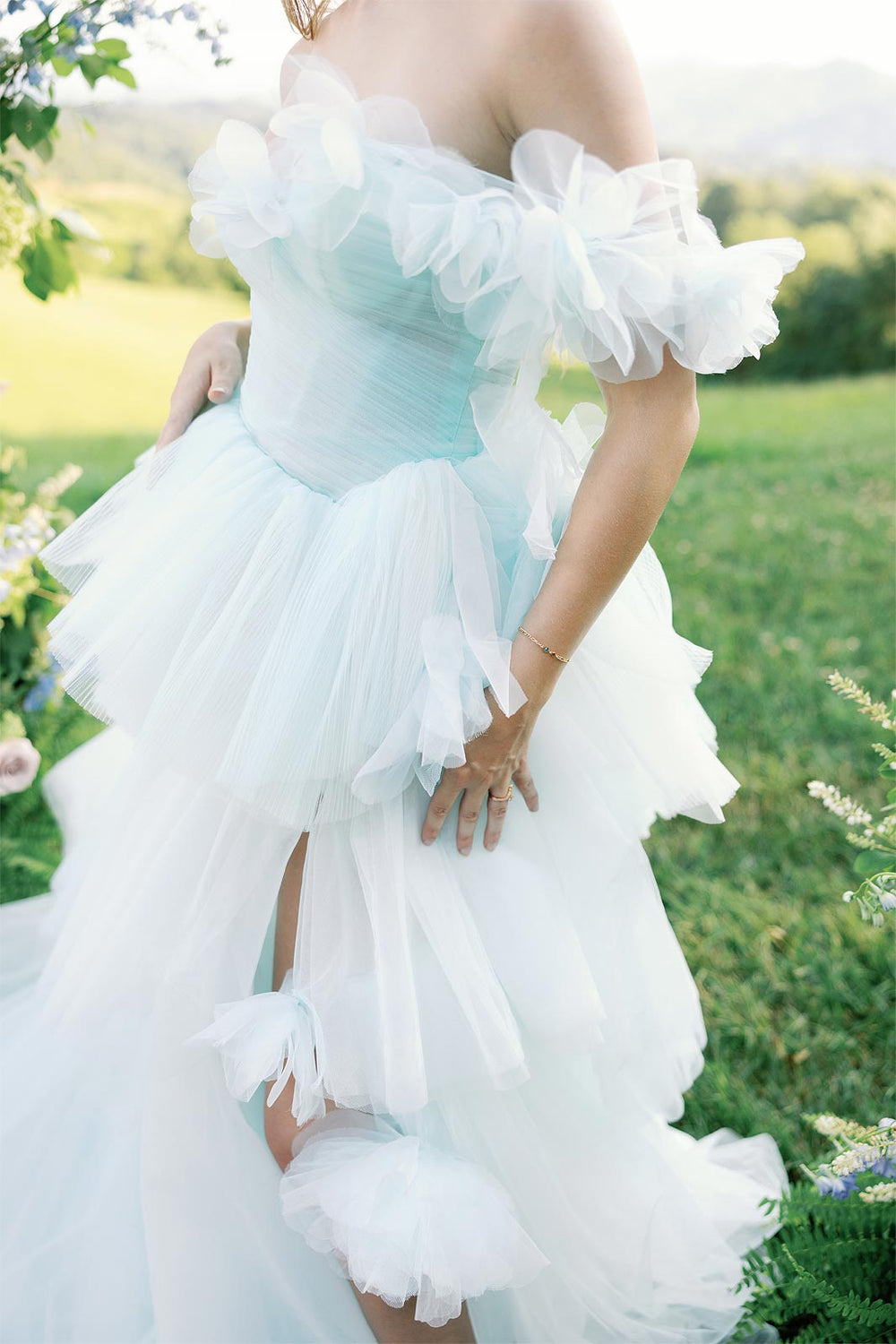 Close-up of the hand-pleated sky-blue tulle tiered skirt on the Belle couture wedding dress
