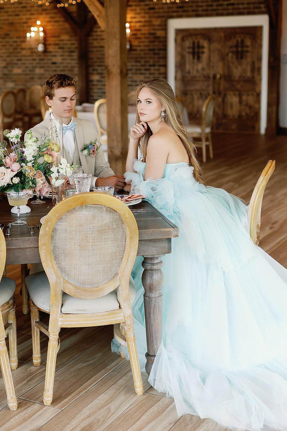 The Belle sky-blue tiered tulle couture wedding gown captured in motion showing the ethereal flow of the pleated skirt
