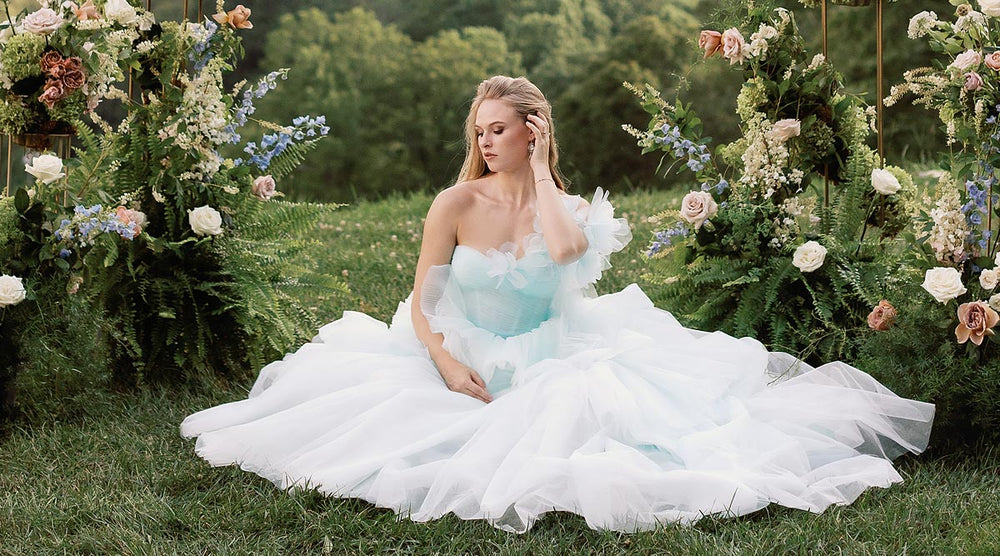 Full-length portrait of bride wearing the Belle sky-blue hand-pleated tiered tulle wedding dress with sweetheart neckline