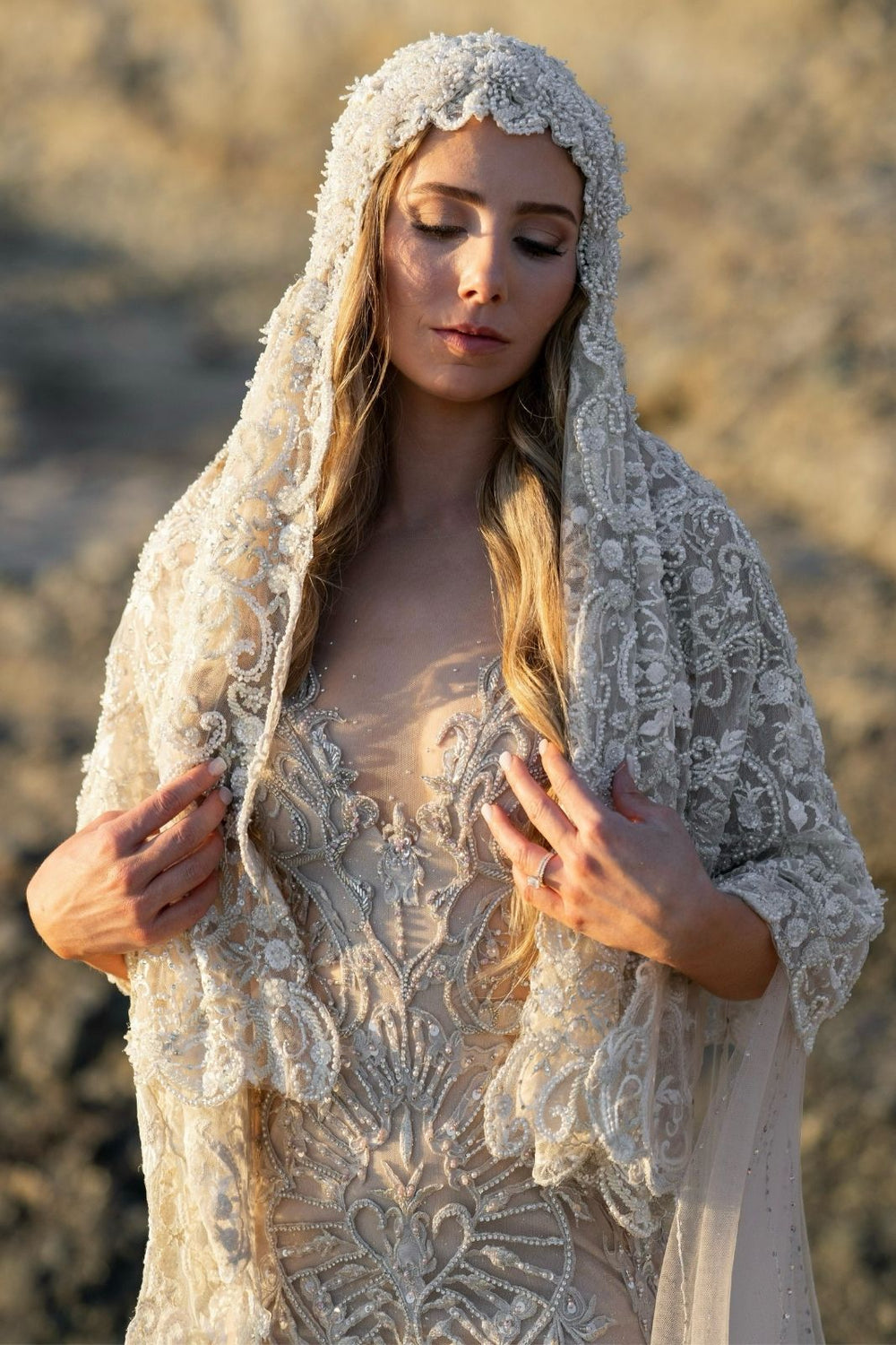 Close portrait of bride wearing the Gigi European hand-beaded lace statement bridal veil framing the face
