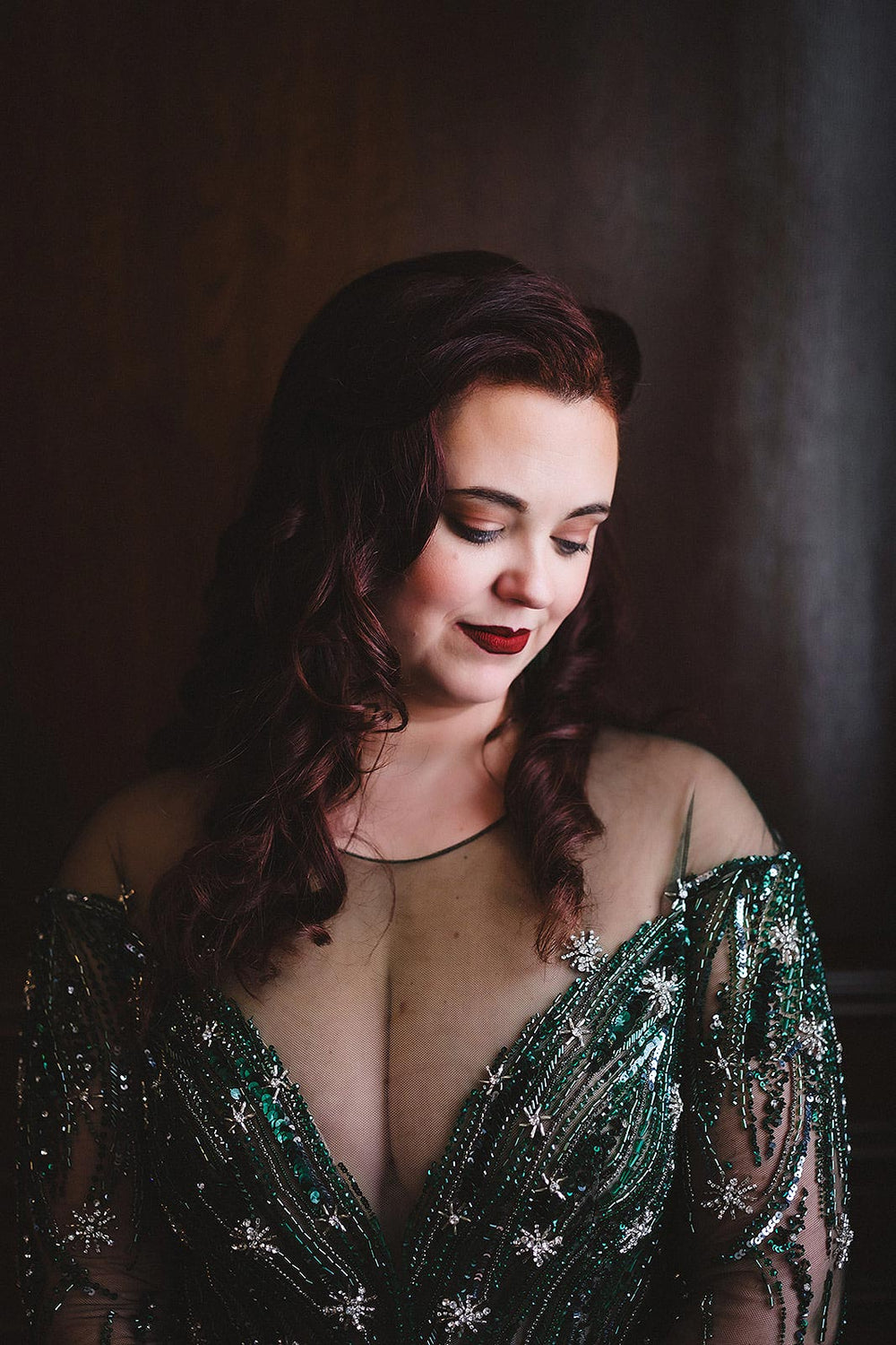 close-up of the plunging V neckline of the Jessica green wedding dress by Angela Kim Couture, showcasing the hand-beaded crystals, glass beads, and sequins in a star and stripe motif against illusion tulle