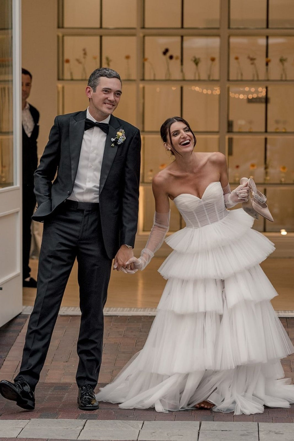 The Rachel A-line tiered tulle wedding dress captured in motion showing the soft flow of the hand-pleated skirt