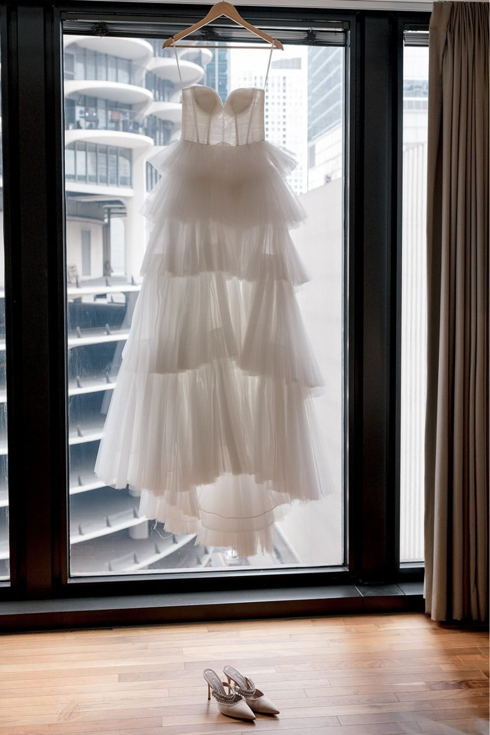 Front view of the Rachel strapless couture wedding dress with structured bustier top and soft tiered tulle skirt
