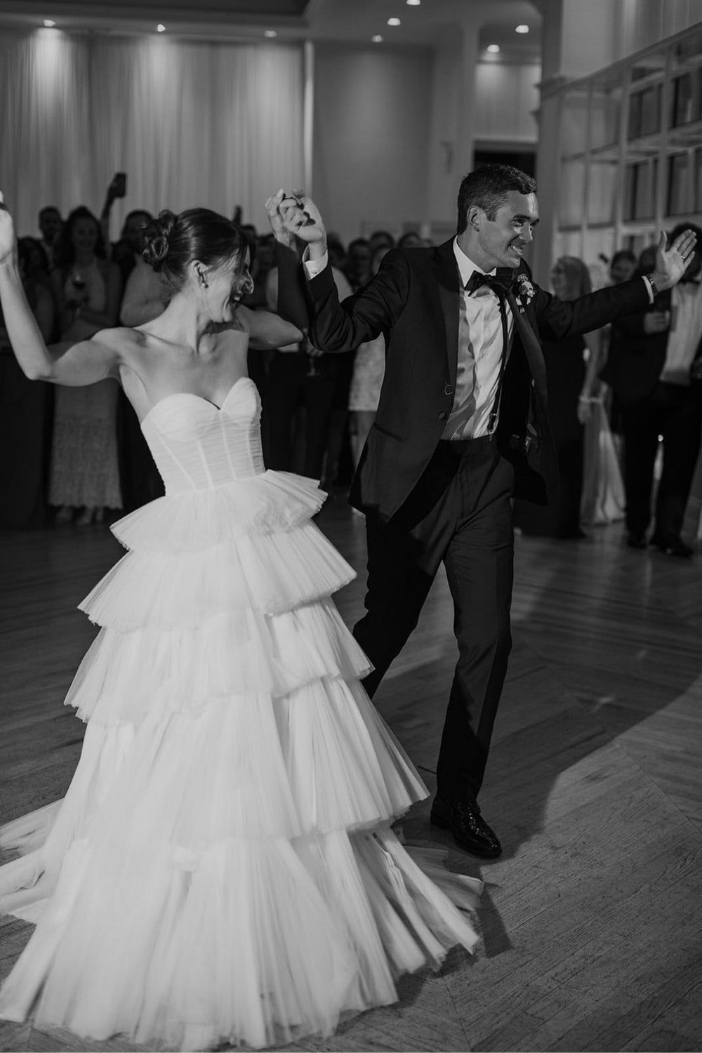 Detail of the Rachel wedding dress tiered tulle skirt and chapel-length train laid out to show full length