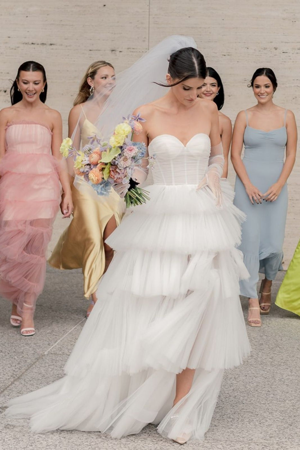 Outdoor bridal portrait of bride in the Rachel wedding dress with chapel train and A-line tulle silhouette
