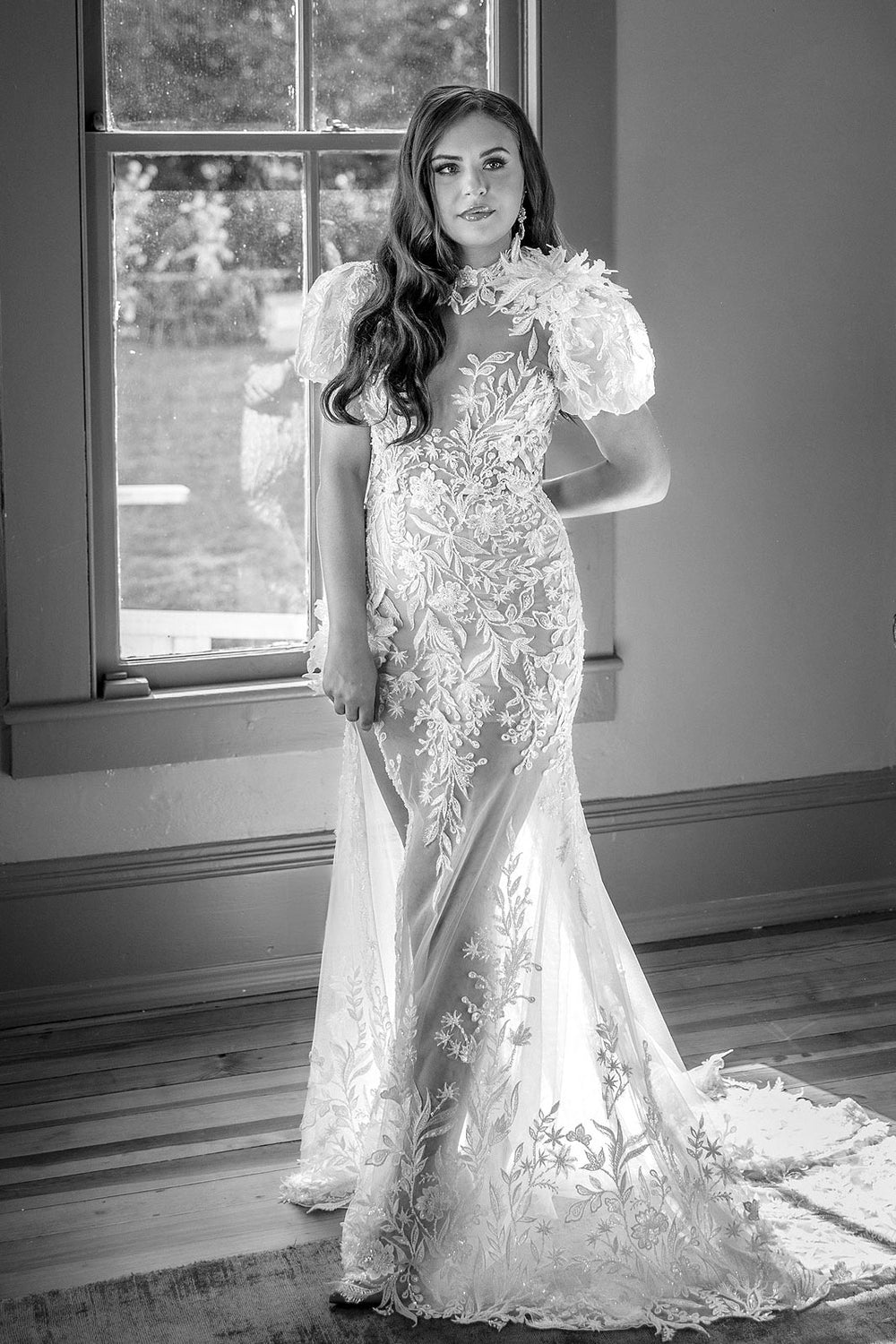 Full view of the Rhea figure-hugging mermaid wedding dress with floral corsage detail and nude illusion lining