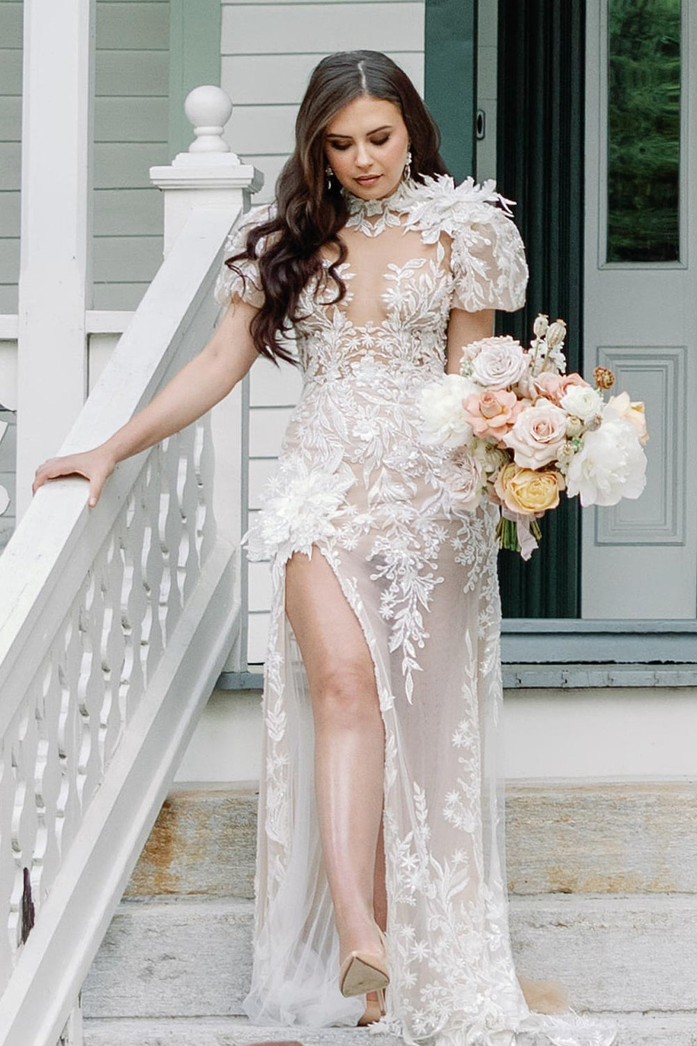 Close-up of the oversized flower corsage adorning the high slit of the Rhea figure-hugging wedding dress skirt