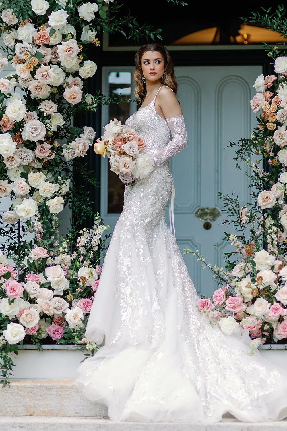 Bride wearing the Rosalie beaded mermaid wedding dress with matching gloves completing the glamorous bridal look