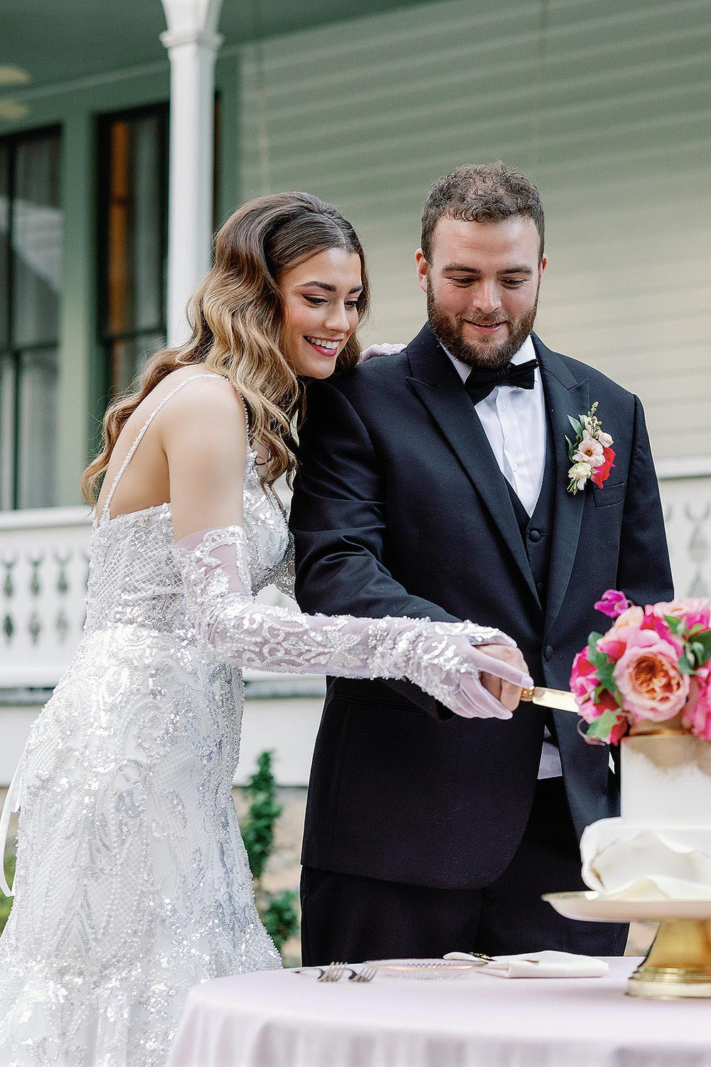 Glamorous bride wearing the Rosalie beaded mermaid bridal gown with gloves 