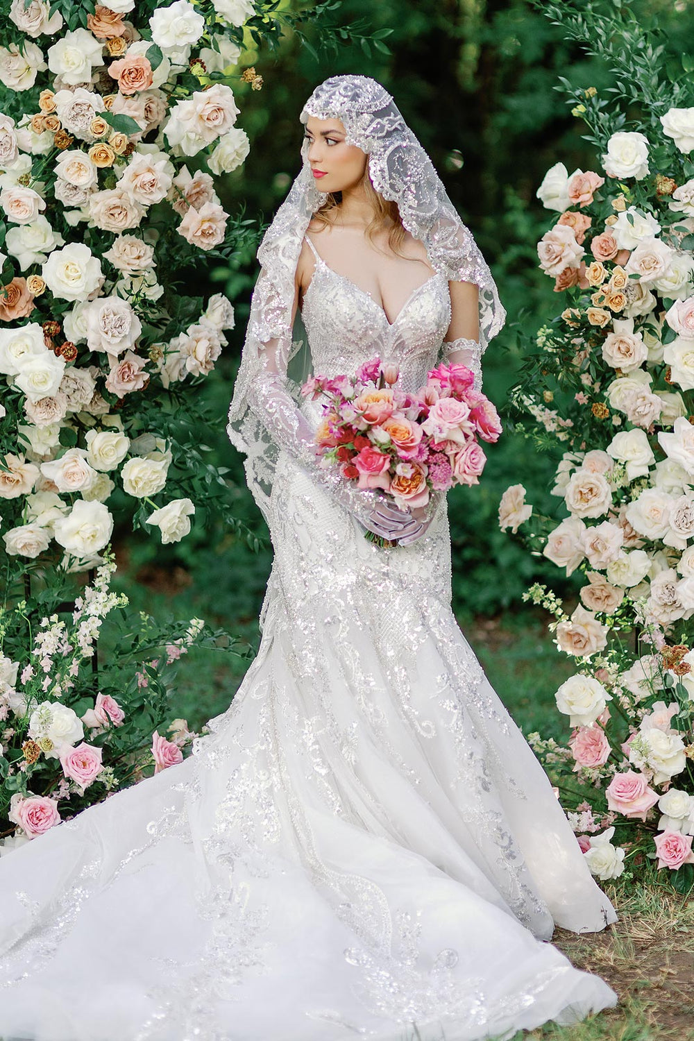 Full-length portrait of bride wearing the Rosalie mermaid wedding dress with a sensual plunging neckline and glamorous beading