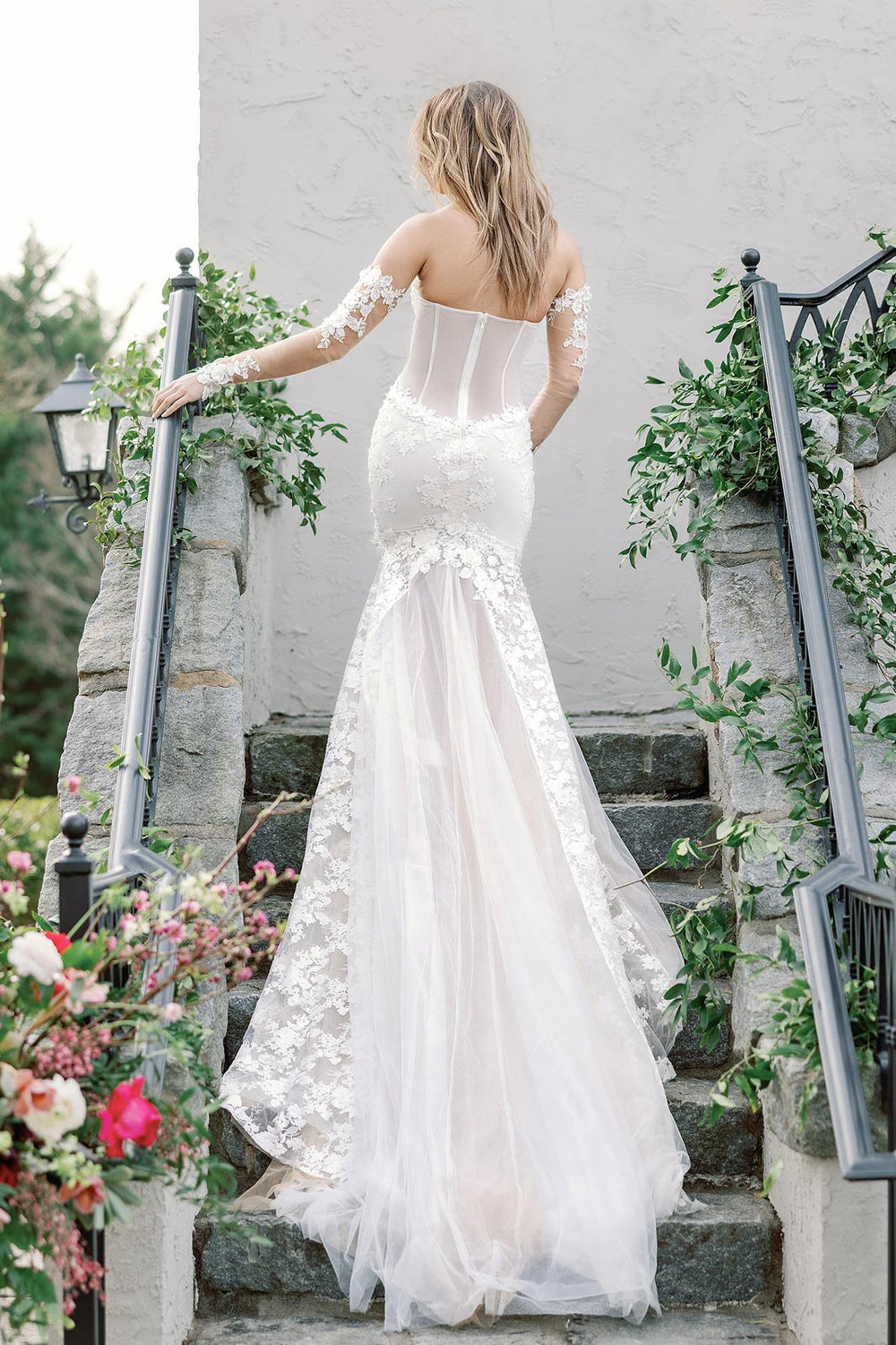 Back view of the Vera couture wedding dress revealing the cutout bodice detail and flowing cathedral train