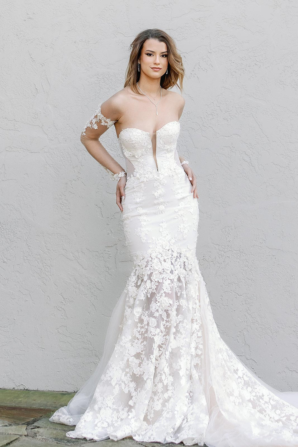 Full-length mermaid silhouette of the Vera couture bridal gown with lace skirt and cathedral train