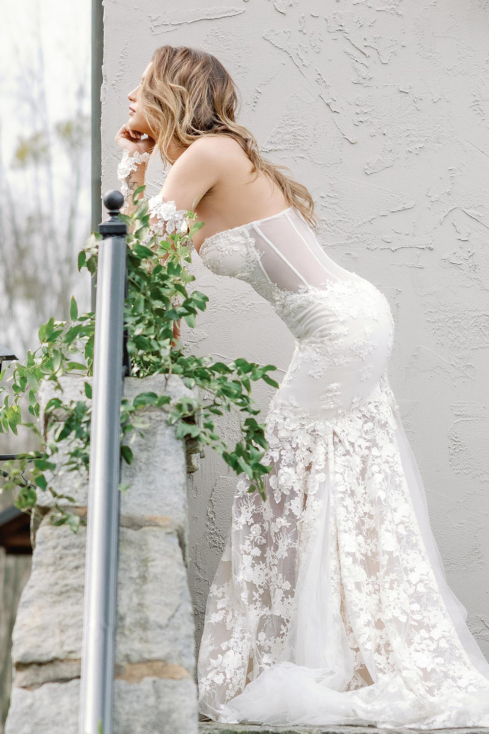 Side view of the Vera form-fitting mermaid couture wedding dress highlighting the cinched waist silhouette