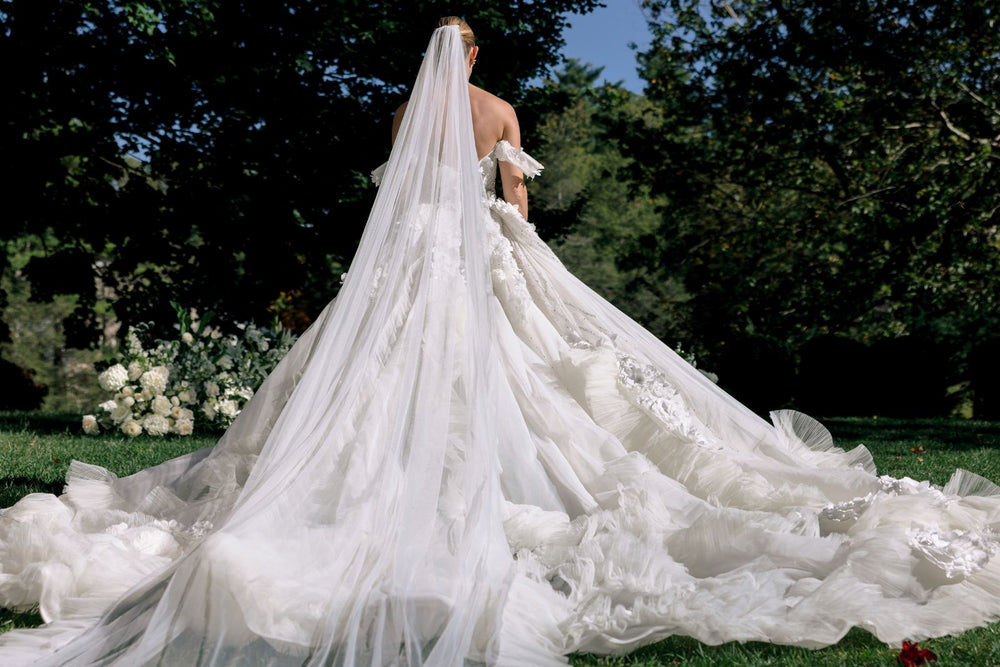 Back view of the Allure custom wedding dress showing the cathedral-length train and corset silhouette