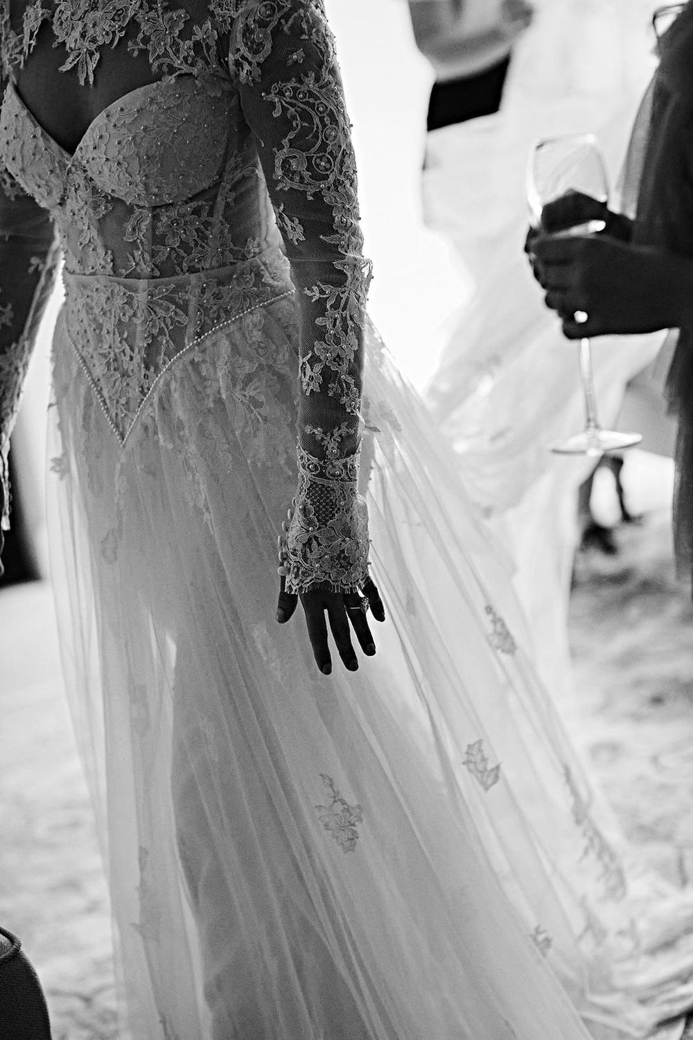 Artistic detail of Blaire's custom lace bolero sleeve and flowing tulle overskirt by Angela Kim Couture 