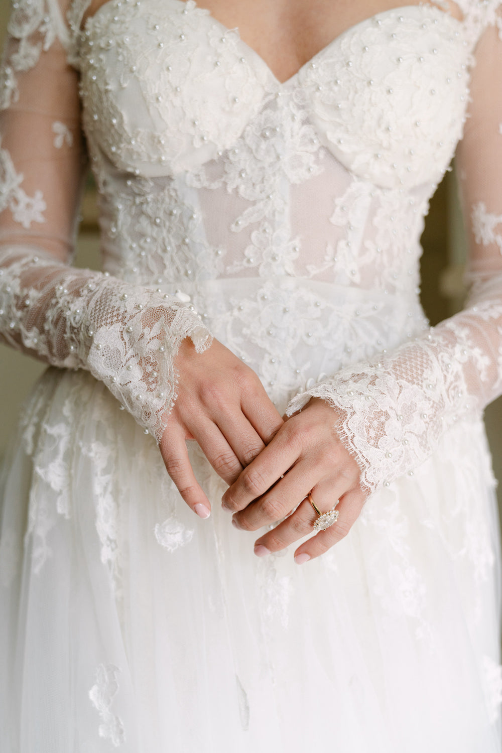 Close-up of Blaire's custom strapless sweetheart neckline by Angela Kim Couture showing the delicate hand-placed pearl and embroidered lace embellishments on the fitted bodice