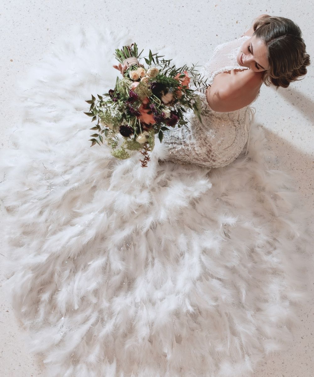 Custom halter neck wedding dress by Angela Kim Couture featuring structured boning and a figure-flattering silhouette made to the bride's exact measurements