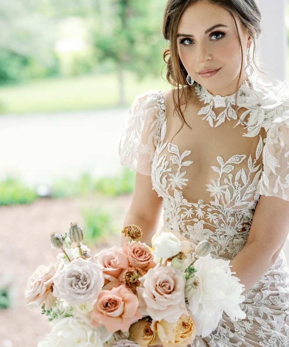 Custom illusion-neckline wedding dress by Angela Kim Couture featuring a sheer lace bodice with intricate embroidery designed as a one-of-a-kind luxury bridal gown