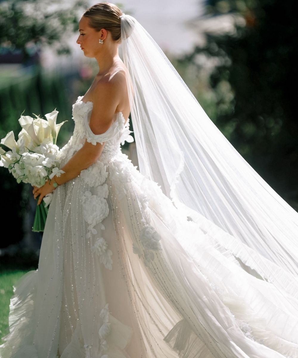 Angela Kim Couture bride in a custom lace wedding dress with 3D floral lace detailing and a dramatic cathedral-length veil