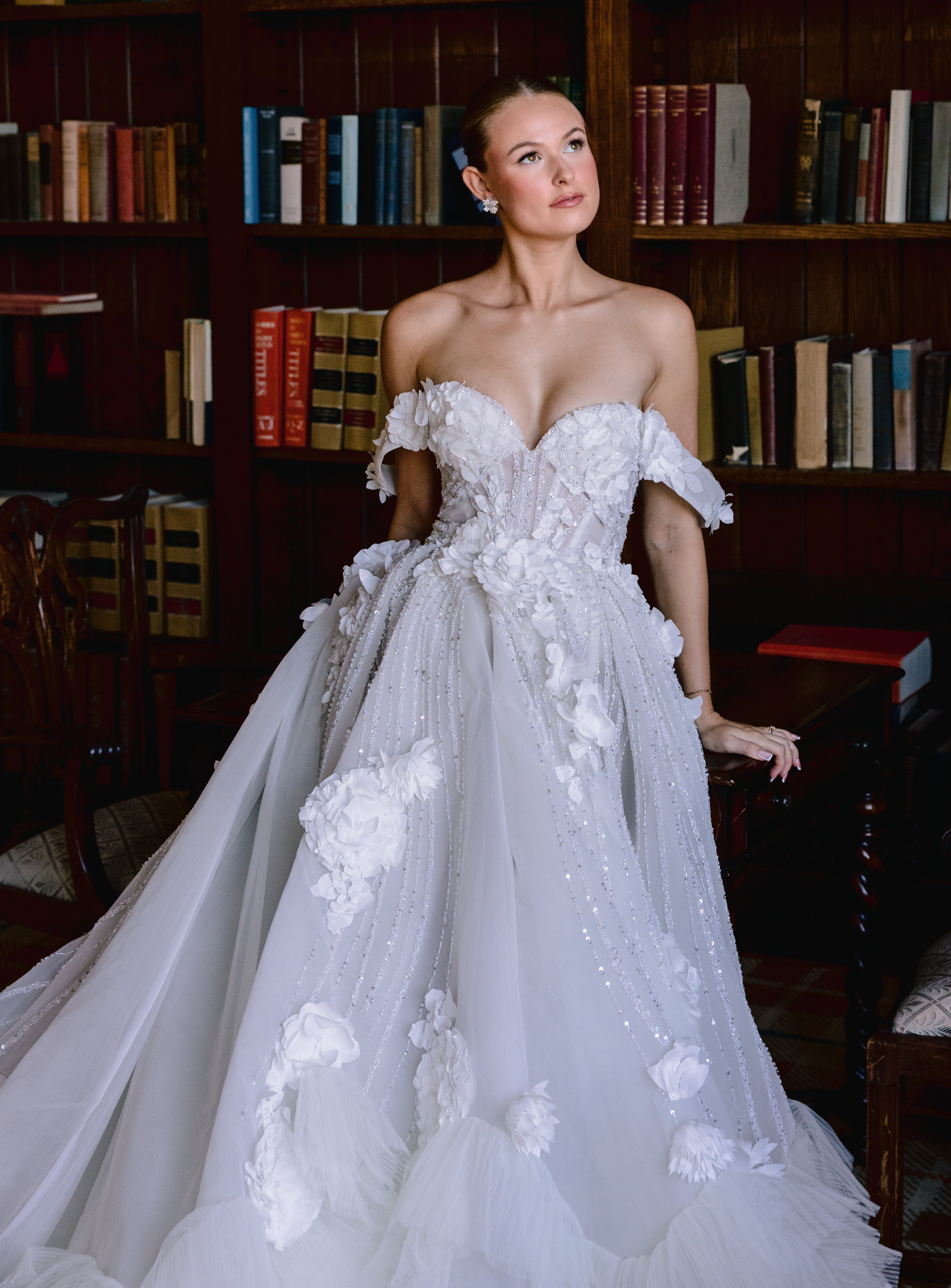 Bride wearing a custom off-shoulder white ballgown with hand-applied 3D floral petals and crystal-embellished corset bodice designed by Angela Kim Couture luxury bridal atelier
