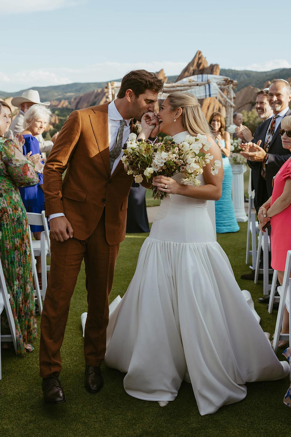 Hannah's custom drop waist and gathered A-line crepe skirt by Angela Kim Couture alongside her groom, showing the built-in boned corset silhouette and bouquet