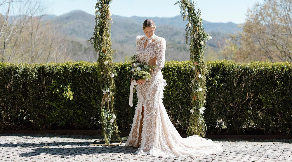 detail of Peyton's custom intricate lace wedding gown by Angela Kim Couture showing the delicate fringe lace hem edge, chic leg slit, and sweeping train 