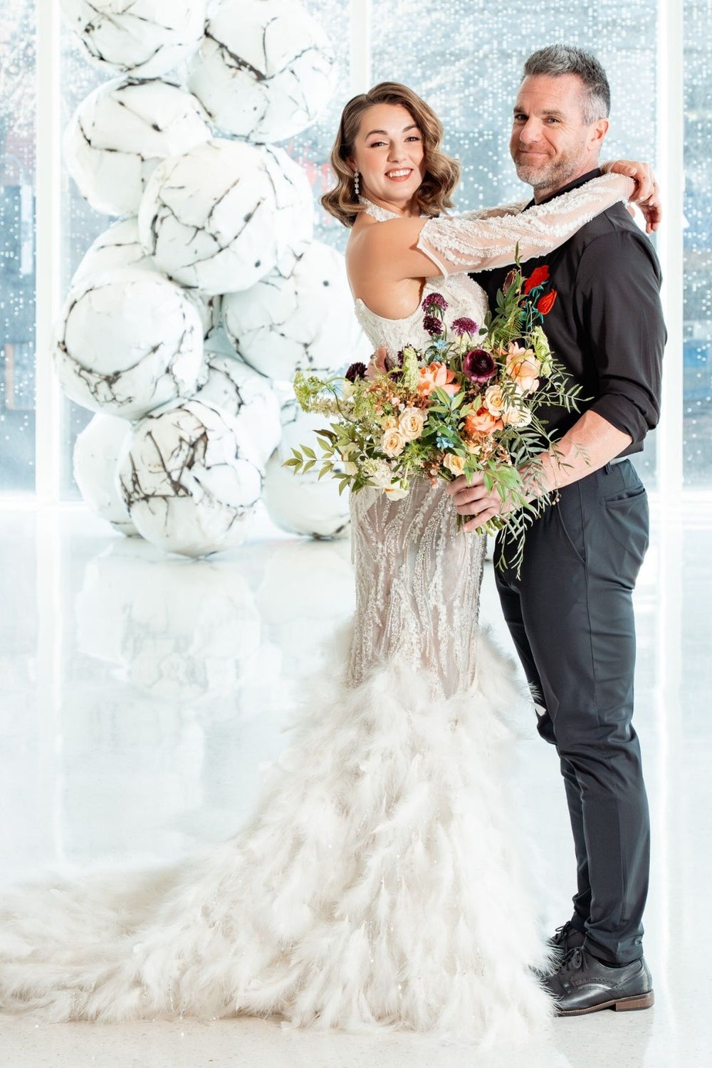 Ayla couture wedding dress featuring hand-placed beads and a feather train for a glamorous bridal look