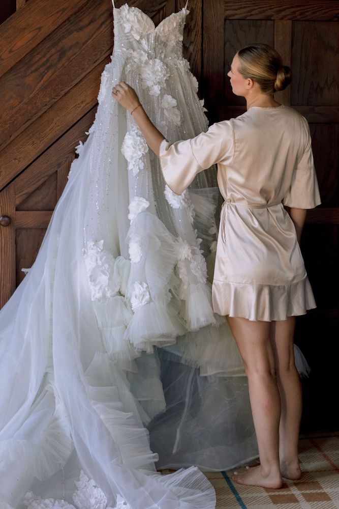 bride admiring the final custom makde couture dress made by Angela Kim Couture