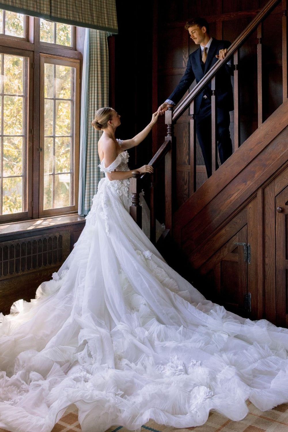 Cathedral-length train of the Allure wedding dress spread on the ground showing intricate detail and length