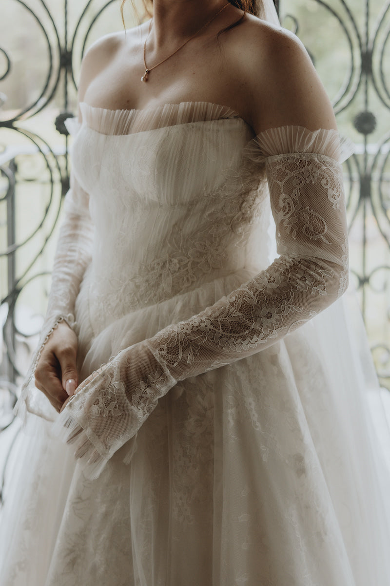 delicate lace details on a wedding dress flattering to petite bride