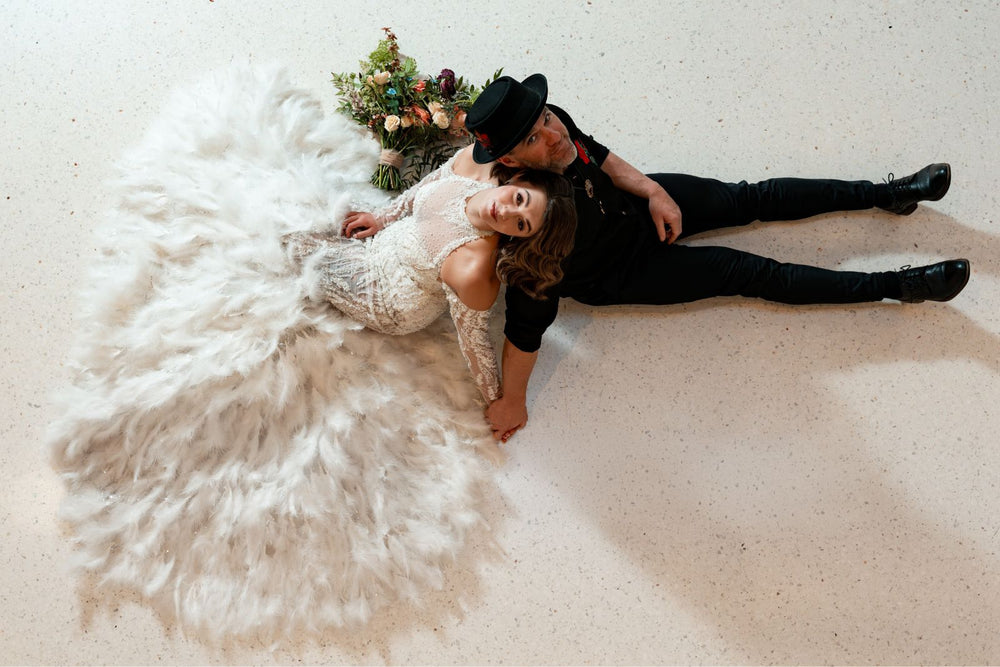 The detachable feather train on the Ayla wedding dress shown attached, adding drama for the ceremony