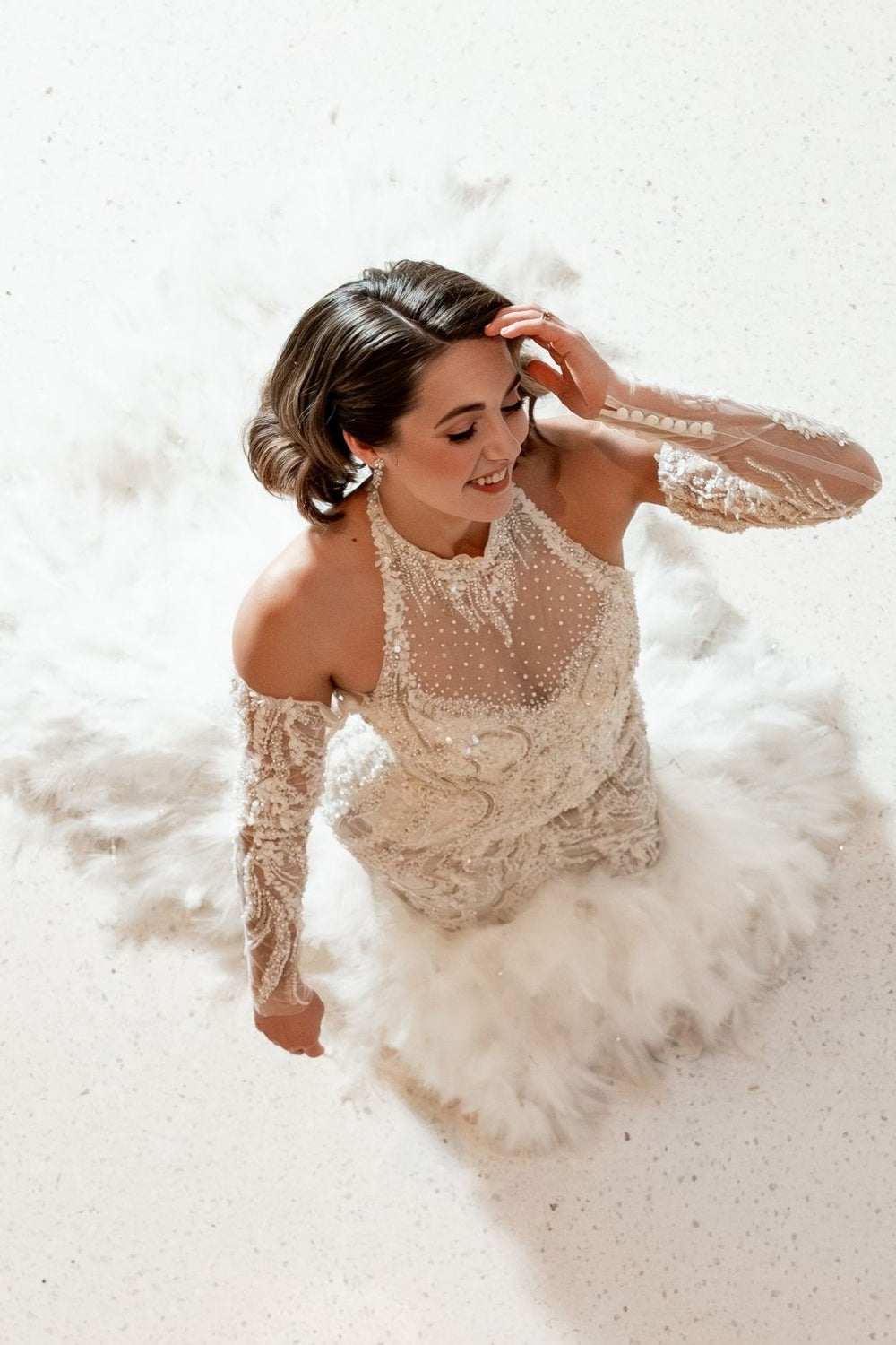 Close-up of intricate hand beading on the Ayla custom couture wedding dress catching light with subtle glamour