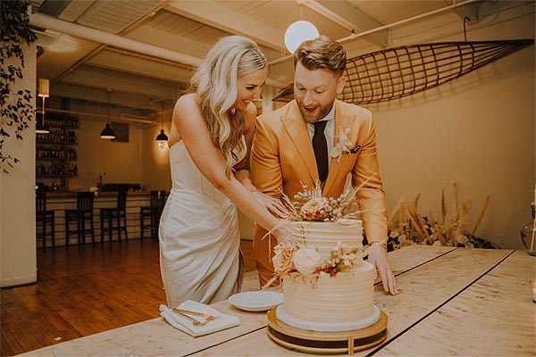 Elizabeth and Jacob cutting their wedding cake.