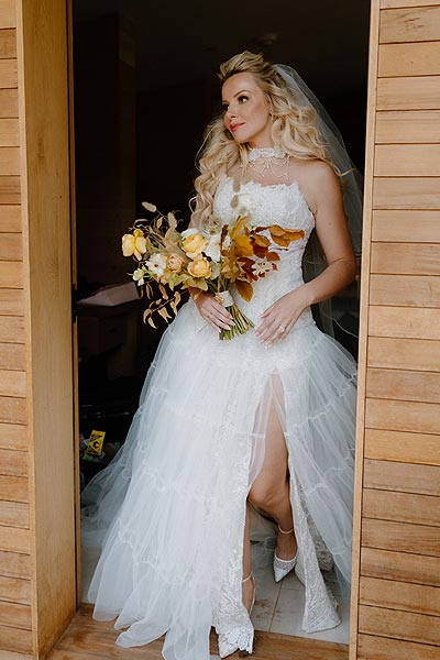 Kaitlin posing in a doorway wearing her custom wedding dress.