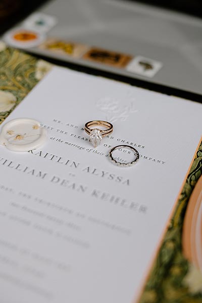 Kaitlin's wedding invitations and wedding rings.