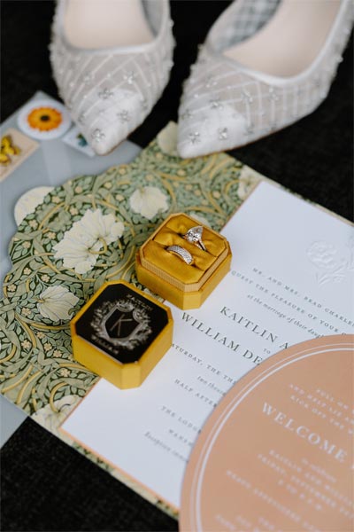 Kaitlin and William's wedding rings and invitations.