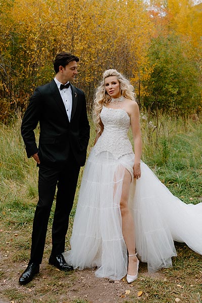 Kaitlin in her wedding gown posing for a wedding portrait with William.