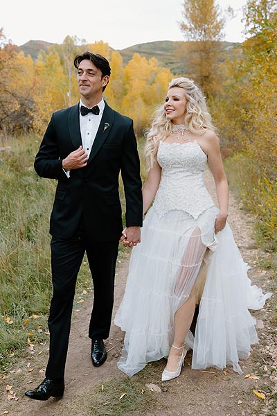 Kaitlin in her custom wedding gown posing with William for a wedding photo.