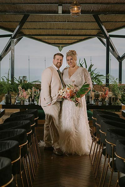 Leah and buddy posing at their wedding venue.