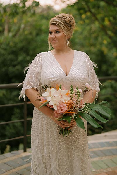 Leah posing for a wedding portrait in her custom bridal gown.