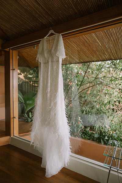 Leah's custom wedding dress on a hanger.