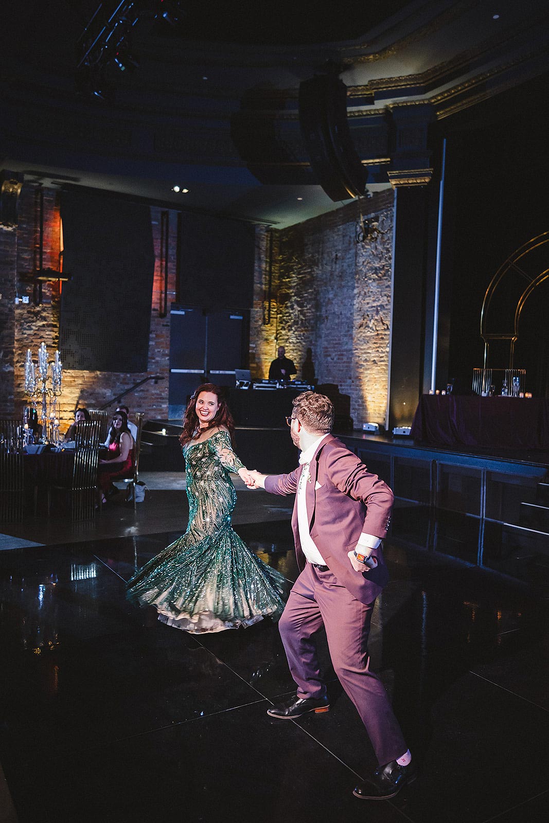 Jessica dancing in her custom green wedding dress