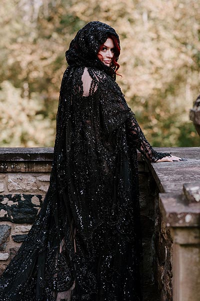 Katie posing in her black custom wedding dress and veil